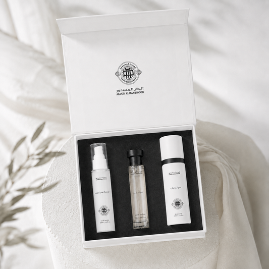 Set of skincare products in a white box with a brand logo on a light background